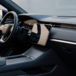 Modern car dashboard interior with large touchscreen infotainment display showing Android Auto interface