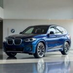 BMW iX3 electric SUV displayed at modern Brazilian dealership showroom