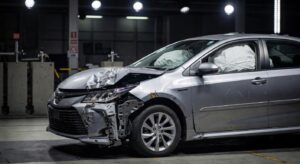 Toyota vehicle showing severe front-end damage in crash test safety evaluation