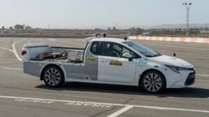 Toyota Corolla hybrid pickup truck prototype with cargo bed during testing phase