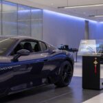 Maserati luxury vehicle in modern showroom setting representing potential business acquisition interest