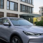 BYD Atto 2 compact hybrid SUV in silver displayed in modern urban environment