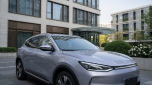 BYD Atto 2 compact hybrid SUV in silver displayed in modern urban environment