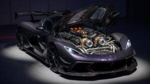 Zenvo Aurora hypercar showcasing its quad-turbo V12 engine with premium carbon fiber and metallic details in professional studio lighting